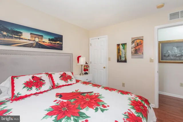 a bedroom with a bed and a painting on the wall