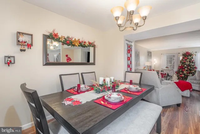 a view of a dining room with furniture wooden floor and a chandelier