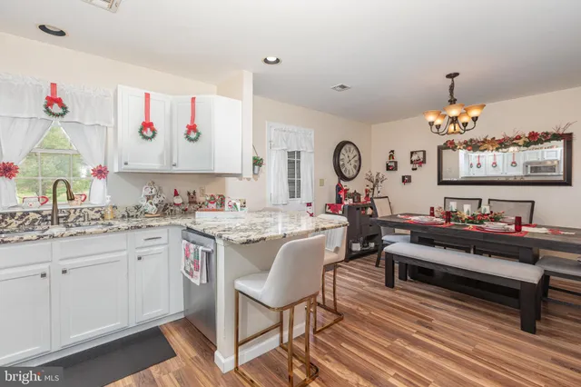 a living room with kitchen island furniture and a chandelier