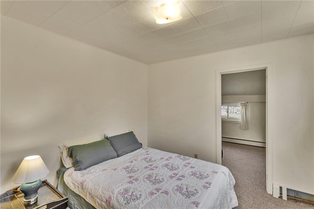 4032 Ewalt Road Gibsonia, PA 15044 - Photo 17 of 39 a bedroom with a bed and a lamp