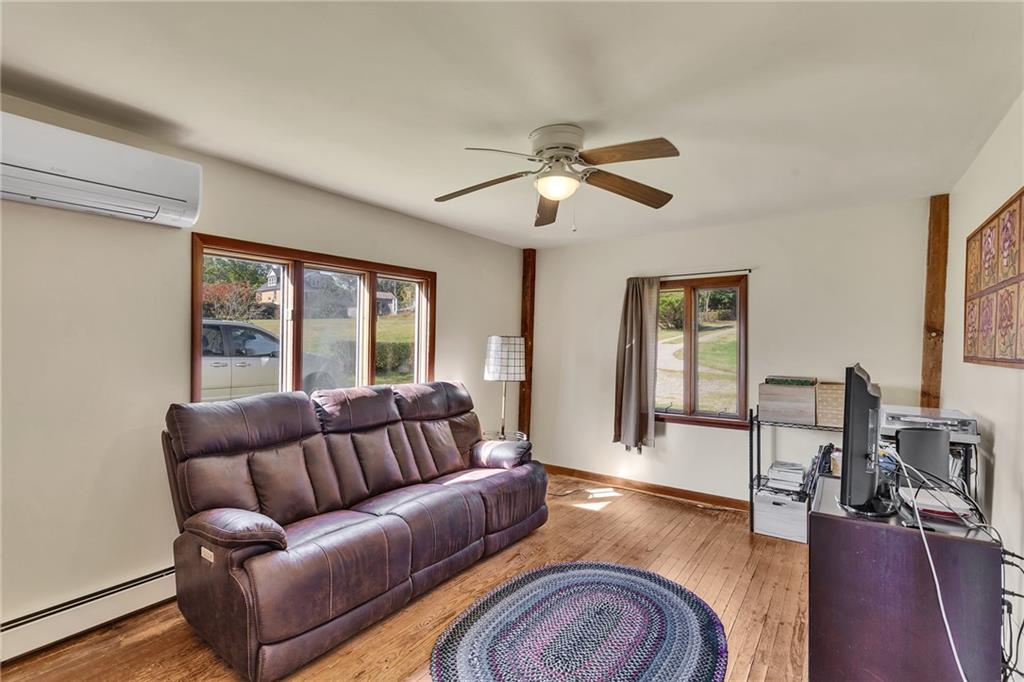 4032 Ewalt Road Gibsonia, PA 15044 - Photo 24 of 39 a living room with furniture ceiling fan and a wooden floor