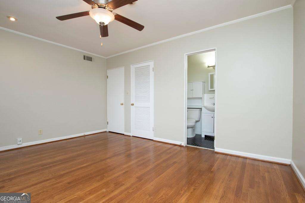 3660 Peachtree Road Northeast, Unit E7 Atlanta, GA 30319 - Photo 13 of 17 a view of an empty room with wooden floor