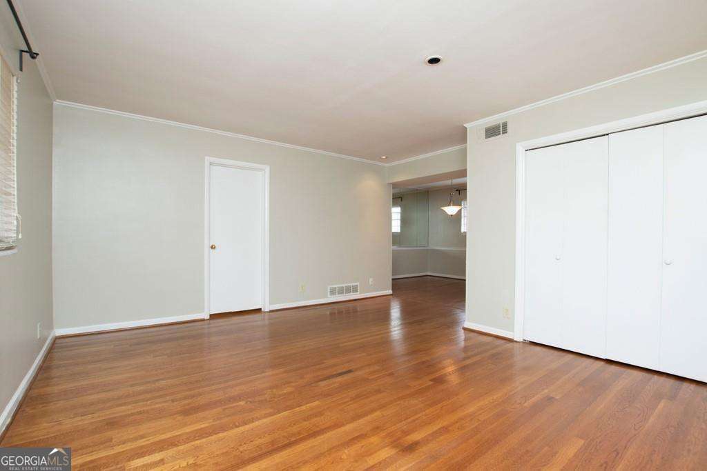 3660 Peachtree Road Northeast, Unit E7 Atlanta, GA 30319 - Photo 4 of 17 a view of an empty room with wooden floor