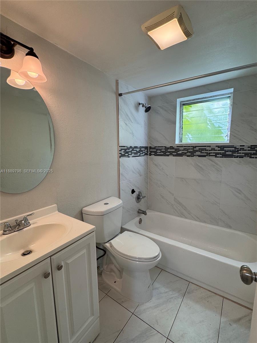 2150 Madison Street, Unit 20 Hollywood, FL 33020 - Photo 9 of 9 a bathroom with a toilet a sink and bathtub