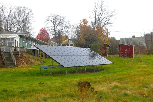 a view of a house with a yard and sitting area
