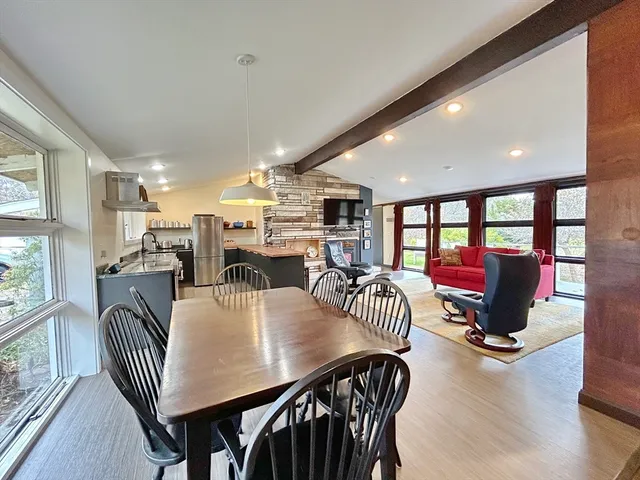 a view of a dining room with furniture window and wooden floor