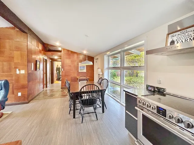 a dining room with furniture and wooden floor