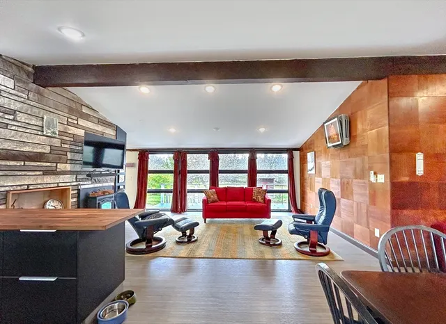 a living room with furniture and floor to ceiling window