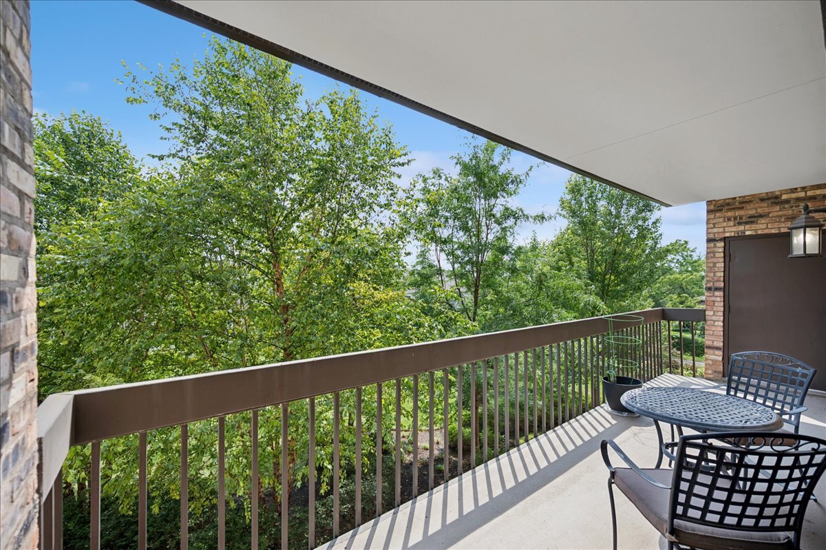 3741 Mission Hills Road, Unit 209 Northbrook, IL 60062 - Photo 11 of 18 a view of a balcony with wooden floor