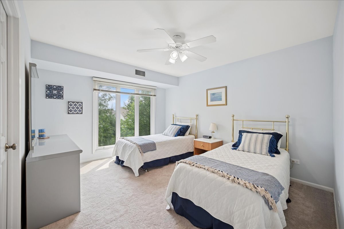 3741 Mission Hills Road, Unit 209 Northbrook, IL 60062 - Photo 15 of 18 a bedroom with two beds and a large window