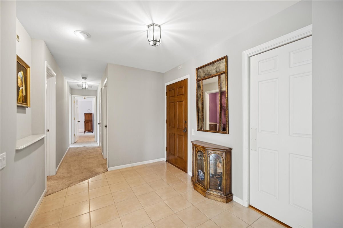 3741 Mission Hills Road, Unit 209 Northbrook, IL 60062 - Photo 2 of 18 a view of an entryway with wooden floor and livingroom view