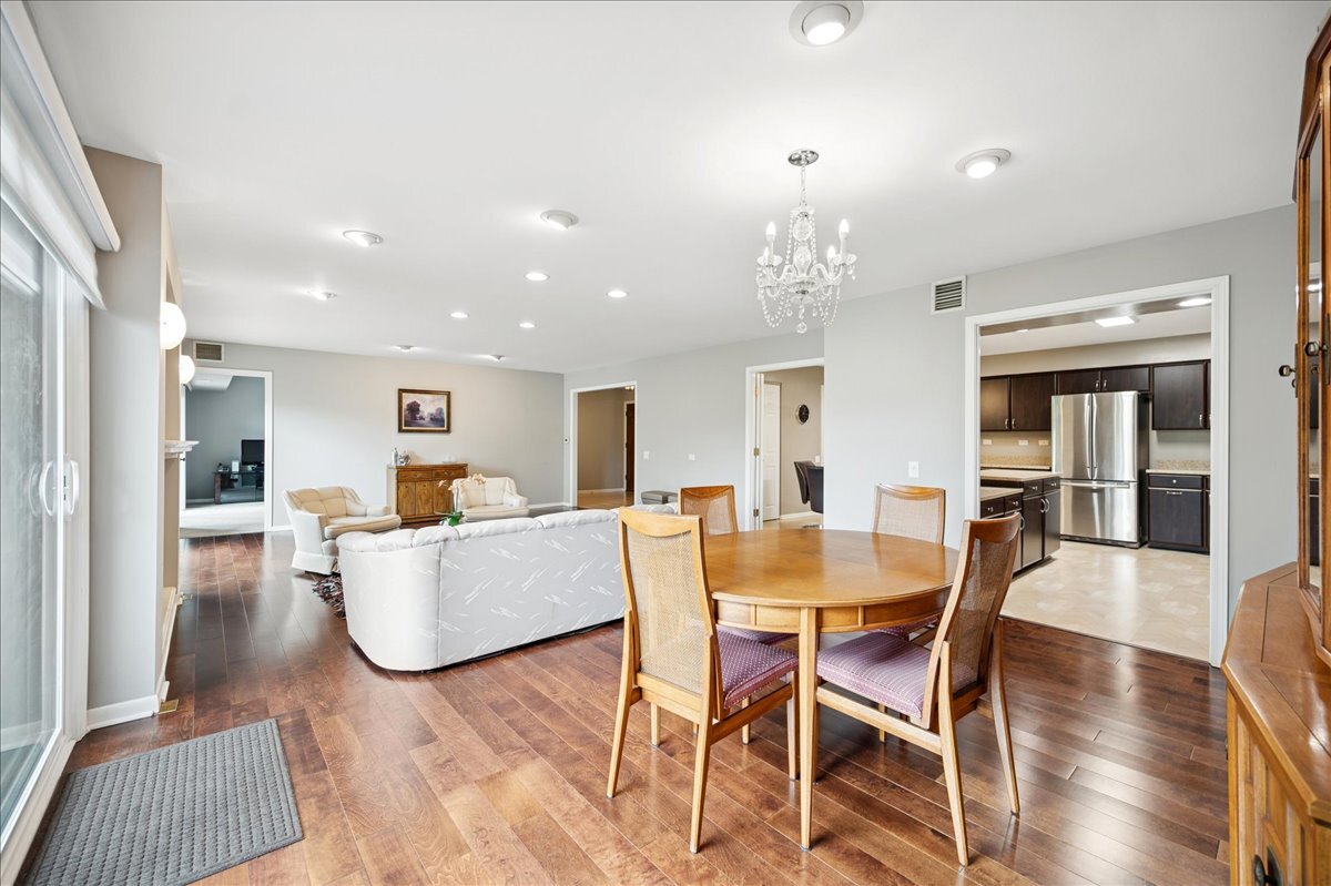 3741 Mission Hills Road, Unit 209 Northbrook, IL 60062 - Photo 5 of 18 a view of a dining room with furniture and wooden floor