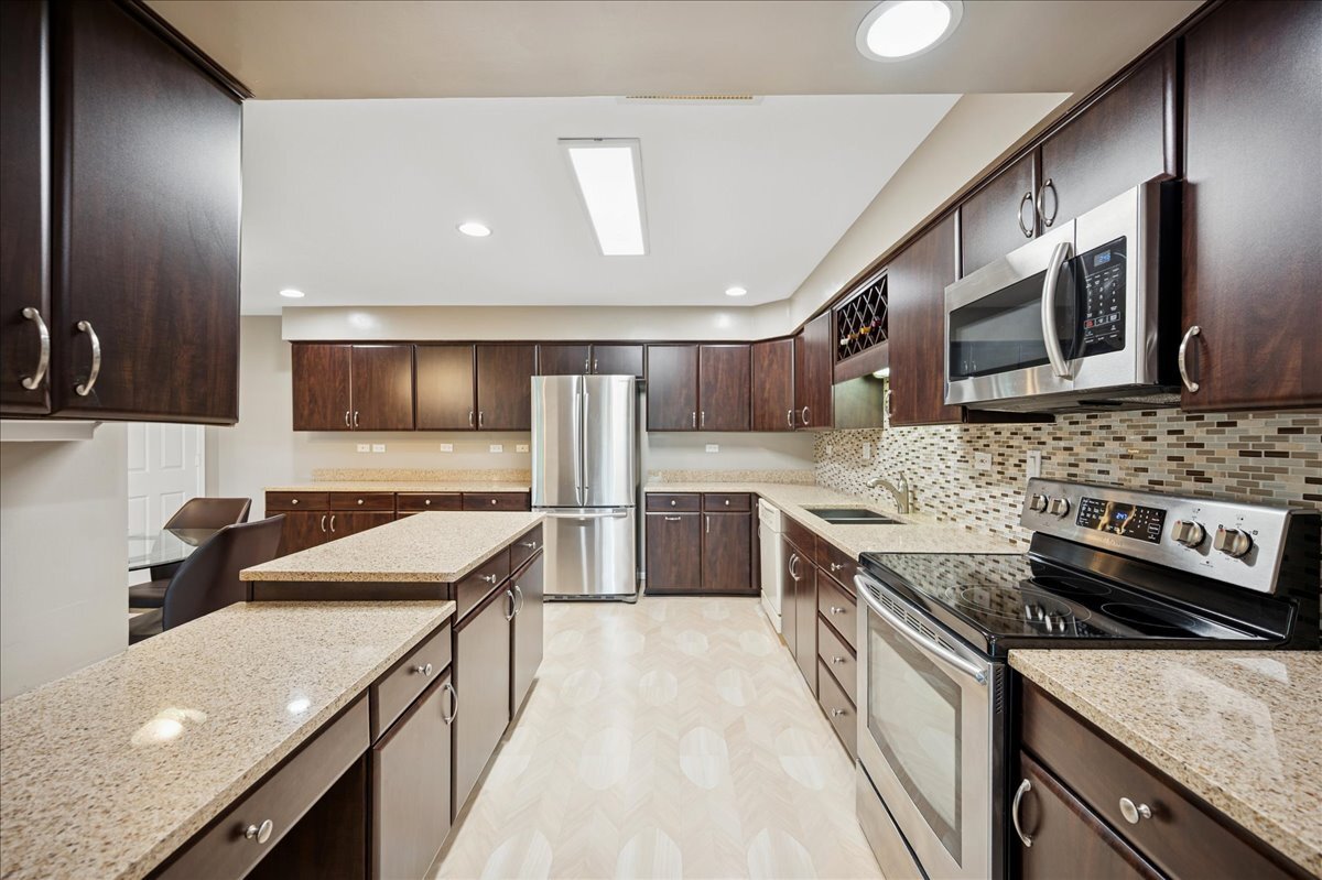 3741 Mission Hills Road, Unit 209 Northbrook, IL 60062 - Photo 6 of 18 a kitchen with stainless steel appliances granite countertop a sink and stove