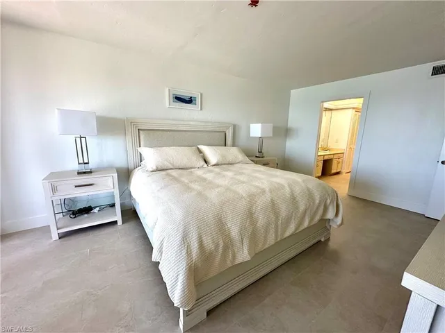 a bed room with a bed and a chair