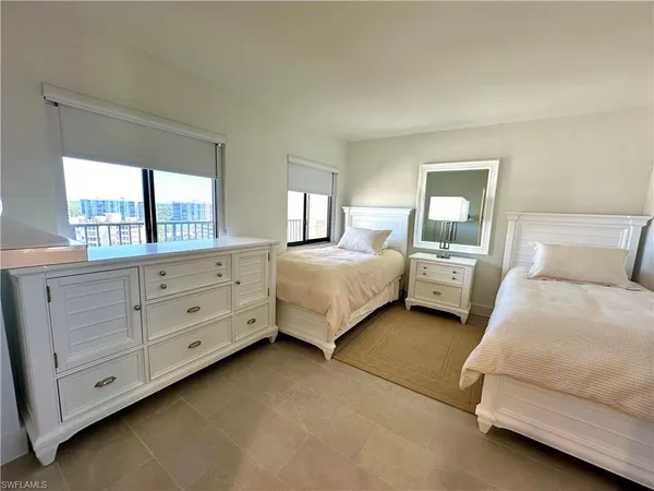 a spacious bedroom with a bed and window