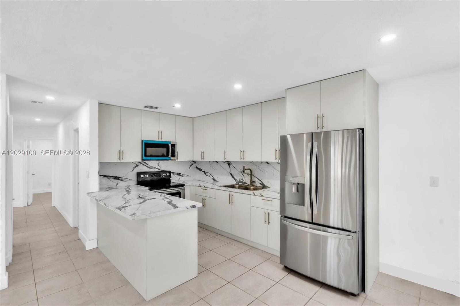 11790 Southwest 34th Street Miami, FL 33175 - Photo 20 of 56 a kitchen with stainless steel appliances a refrigerator sink and microwave