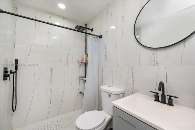 a bathroom with a sink toilet and shower