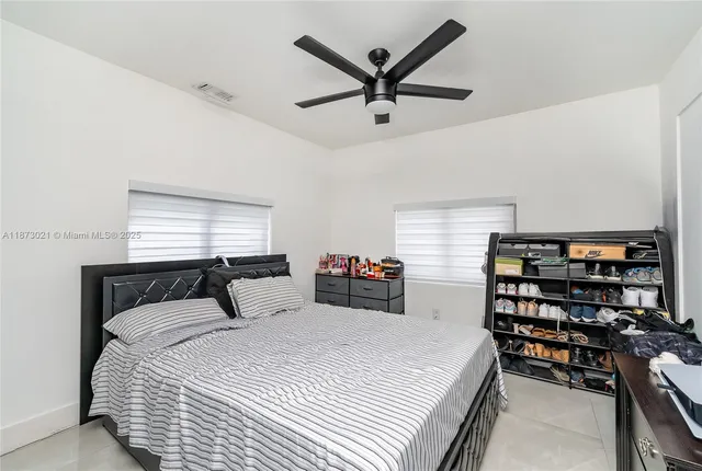 a bedroom with a bed and a large window