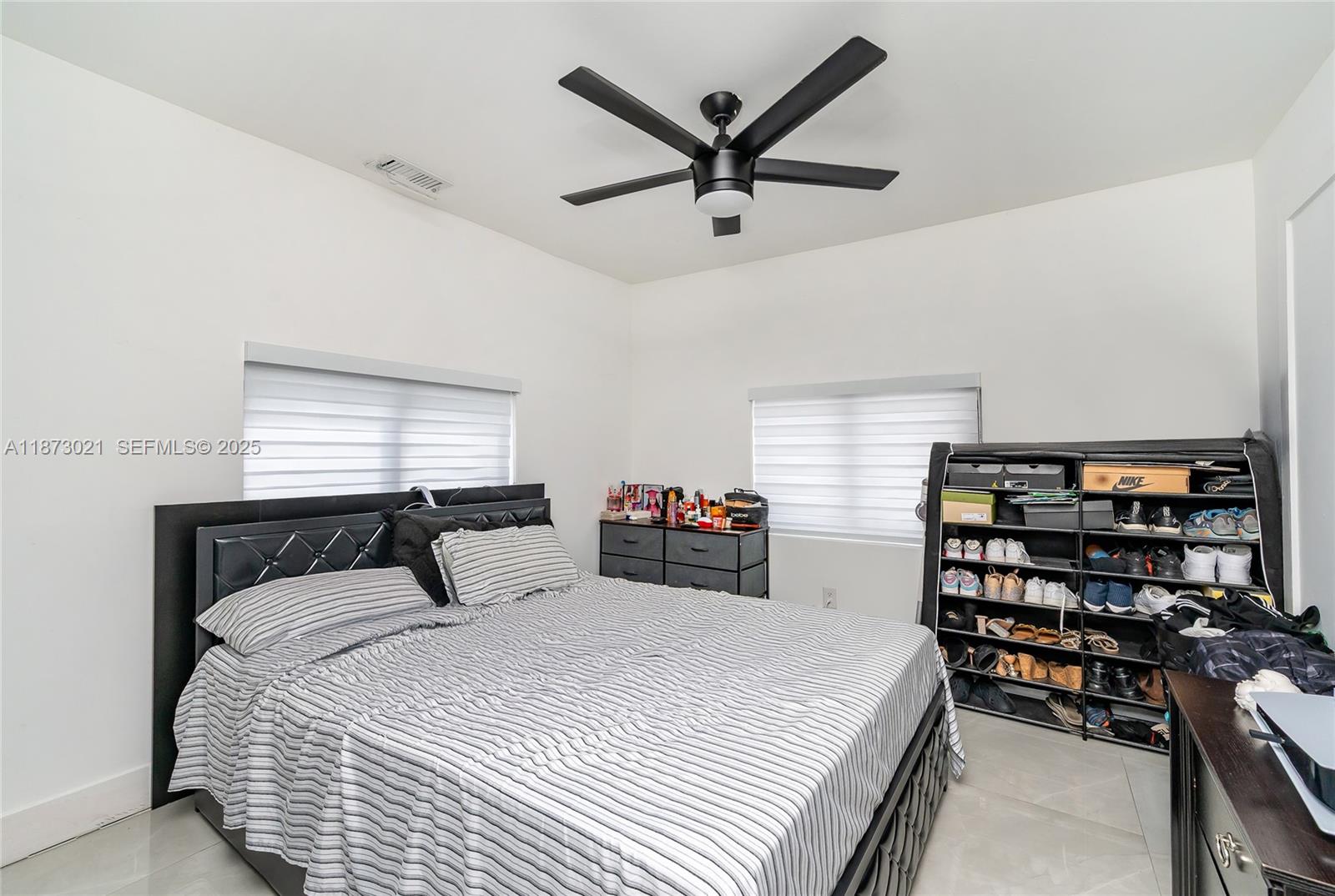 1946 Northwest 49th Street Miami, FL 33142 - Photo 13 of 29 a bedroom with a bed and a large window