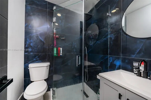 a bathroom with a toilet a sink and shower
