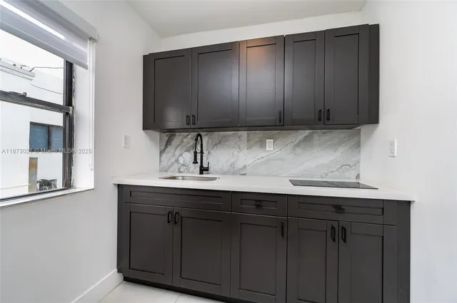 a kitchen with a sink and cabinets