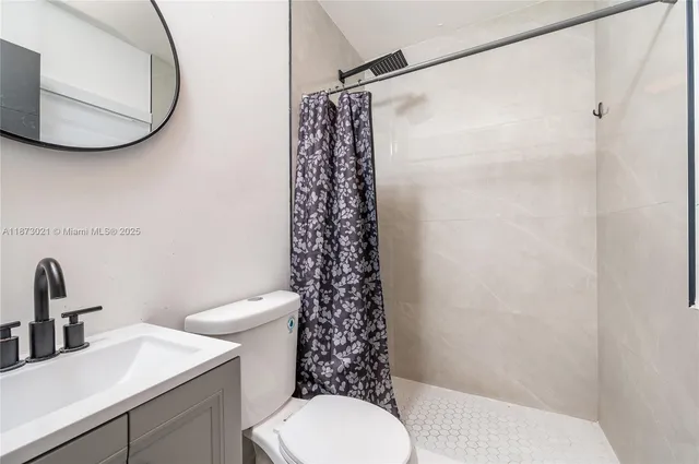 a bathroom with a sink toilet and a mirror