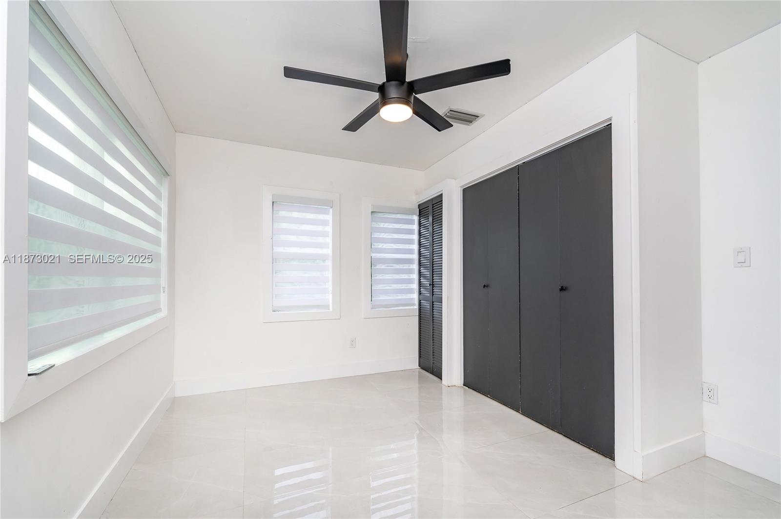 1946 Northwest 49th Street Miami, FL 33142 - Photo 28 of 29 a view of a livingroom with a ceiling fan and window