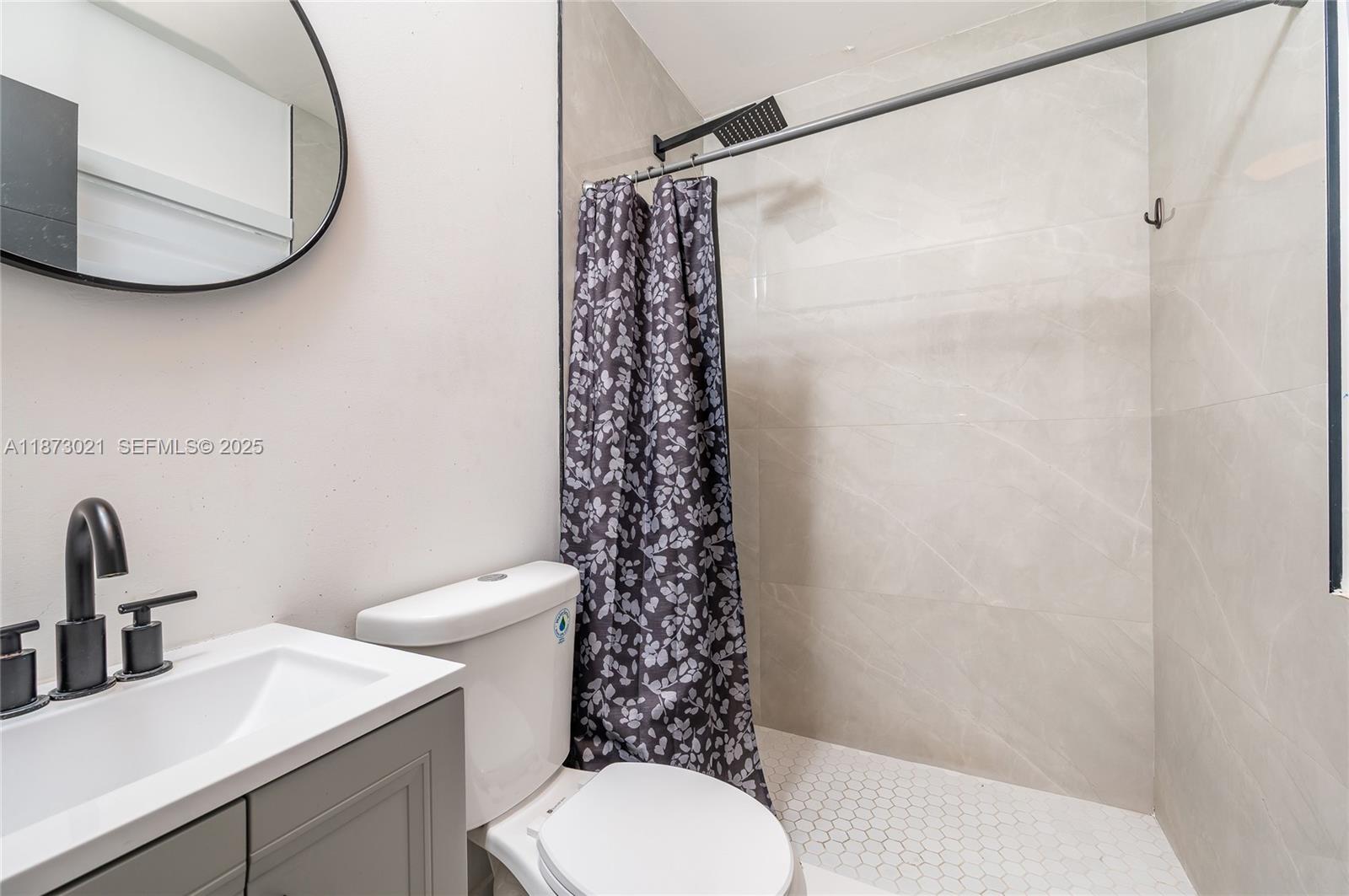 1946 Northwest 49th Street Miami, FL 33142 - Photo 29 of 29 a bathroom with a sink toilet and a mirror