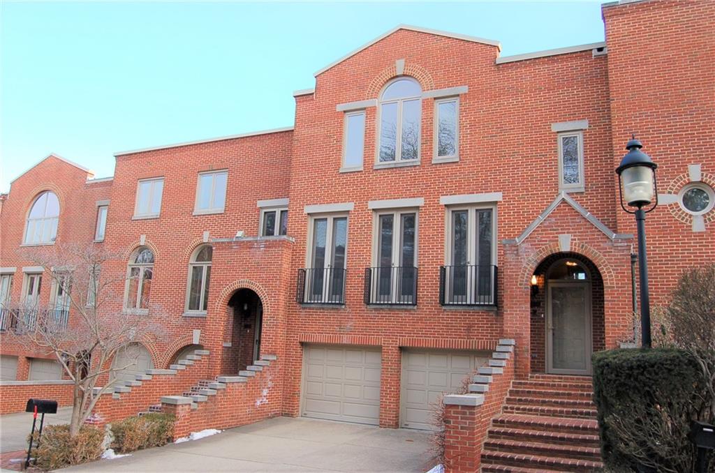 a front view of a house with many windows