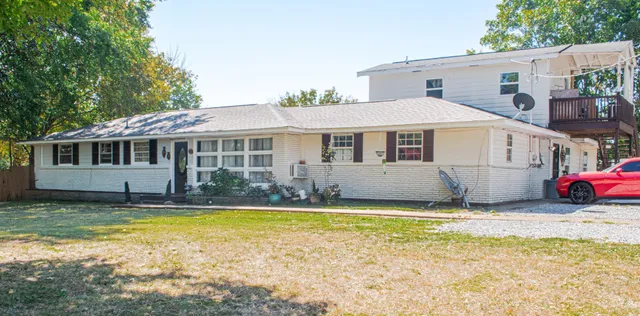 a view of a house with swimming pool and sitting area