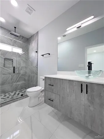 a bathroom with a sink a toilet and shower