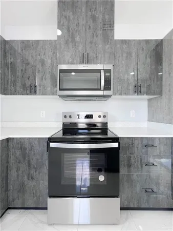 a stove top oven sitting inside of a kitchen
