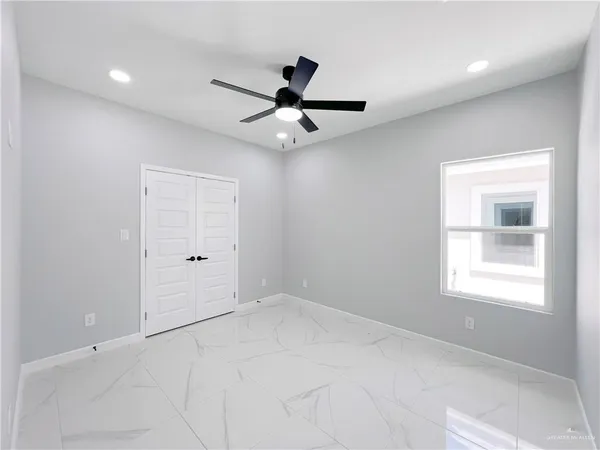 a view of an empty room with a window