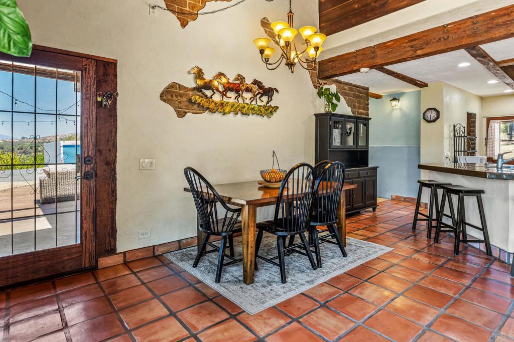 17089 Lawson Valley Road Jamul, CA 91935 - Photo 13 of 33 a view of a dining room with furniture and chandelier