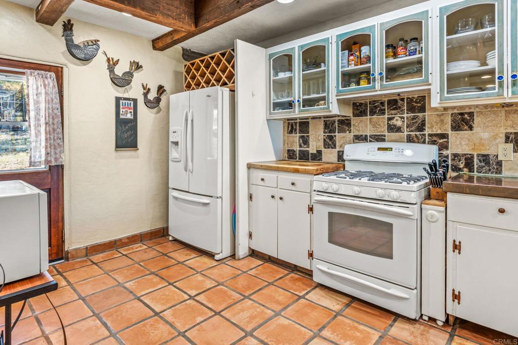 17089 Lawson Valley Road Jamul, CA 91935 - Photo 14 of 33 a kitchen with a stove and a refrigerator
