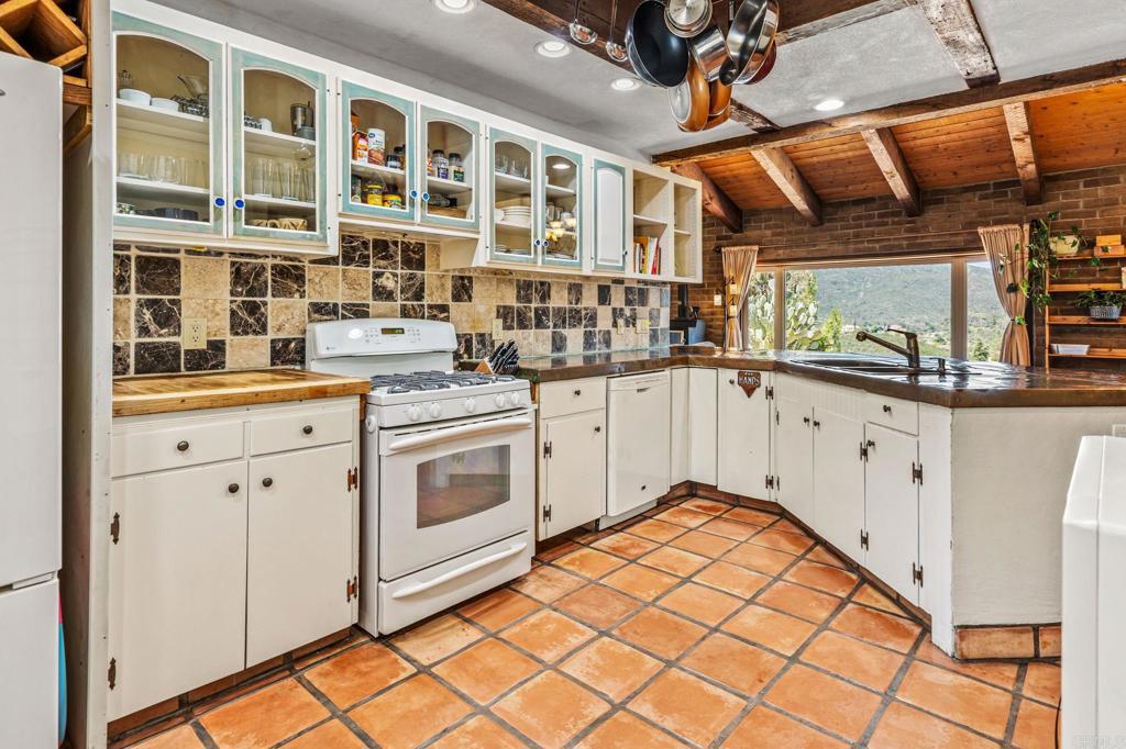 17089 Lawson Valley Road Jamul, CA 91935 - Photo 15 of 33 a kitchen with stainless steel appliances granite countertop a stove and a sink