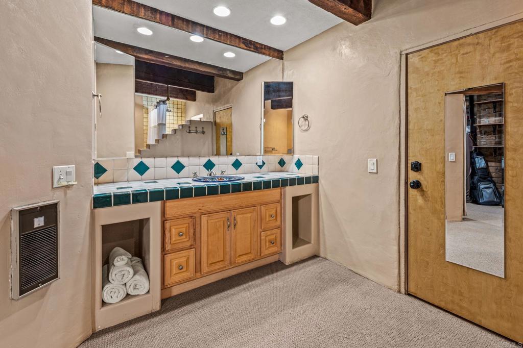 17089 Lawson Valley Road Jamul, CA 91935 - Photo 20 of 33 a bathroom with a sink double vanity and a mirror