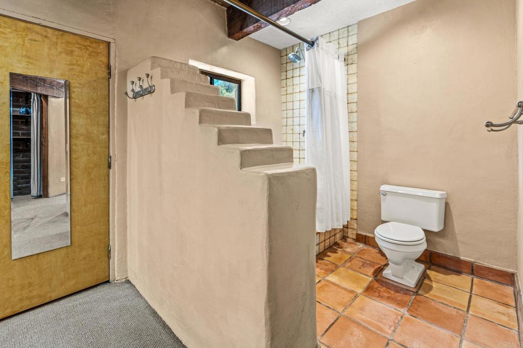 17089 Lawson Valley Road Jamul, CA 91935 - Photo 21 of 33 a bathroom with a toilet and a shower