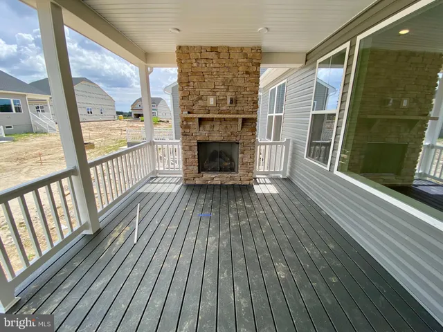 a view of an empty room with floor to ceiling windows