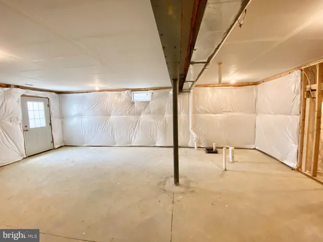 a front view of a house with a lake and a lot of flowers in it