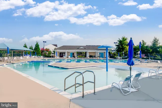 a view of a dining room with furniture large windows and wooden floor