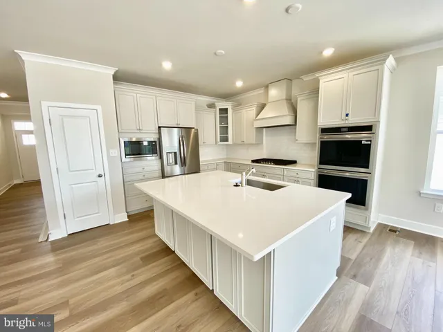 a view of an empty room and wooden floor