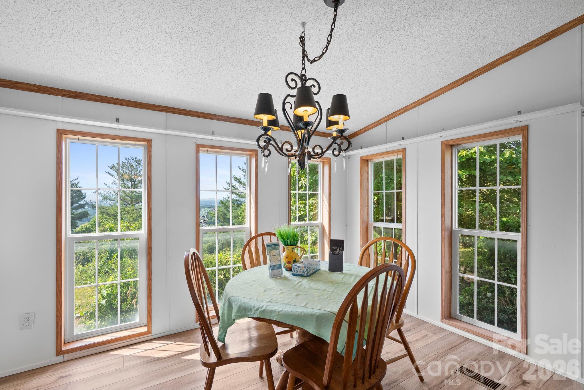 133 Spivey Mountain Road Asheville, NC 28806 - Photo 7 of 40 a view of a dining room with furniture window and outside view