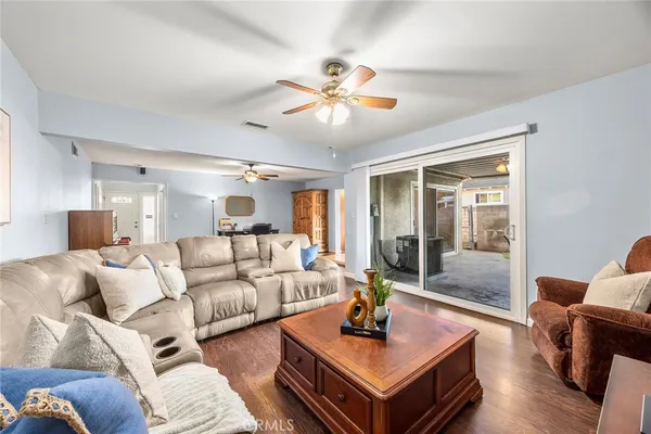 a living room with furniture a rug and a chandelier