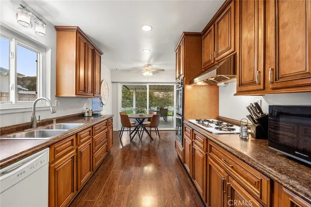 a kitchen with wooden cabinets and black appliances
