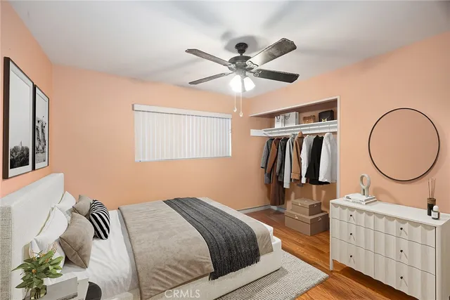 a bedroom with bed and a chandelier