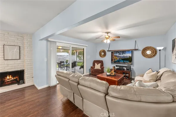 a living room with furniture fireplace and a window