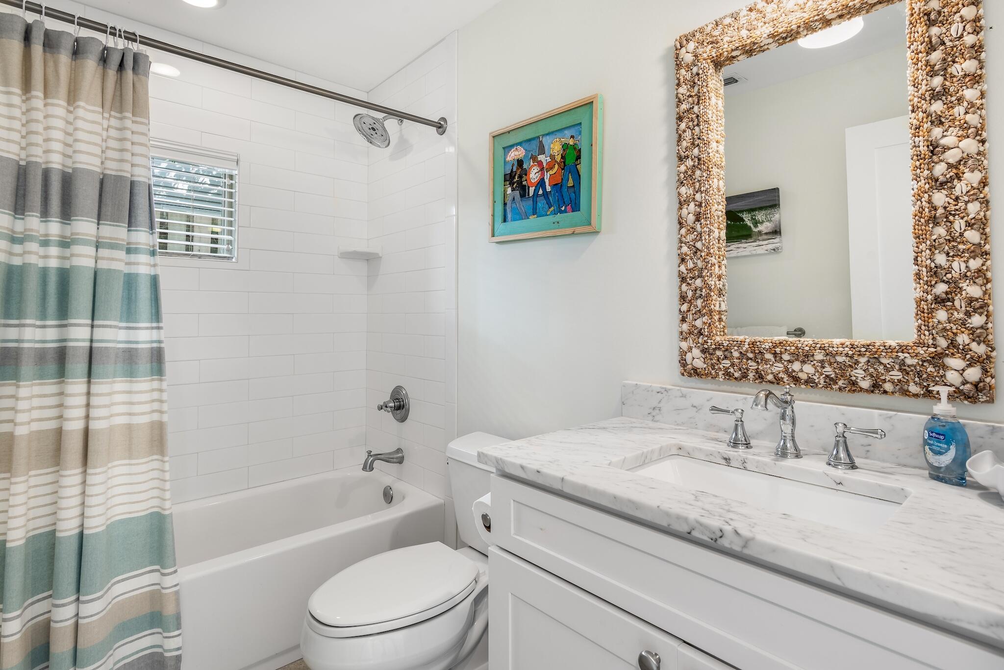 301 South Gulf Drive Santa Rosa Beach, FL 32459 - Photo 16 of 26 a bathroom with a granite countertop sink toilet and shower