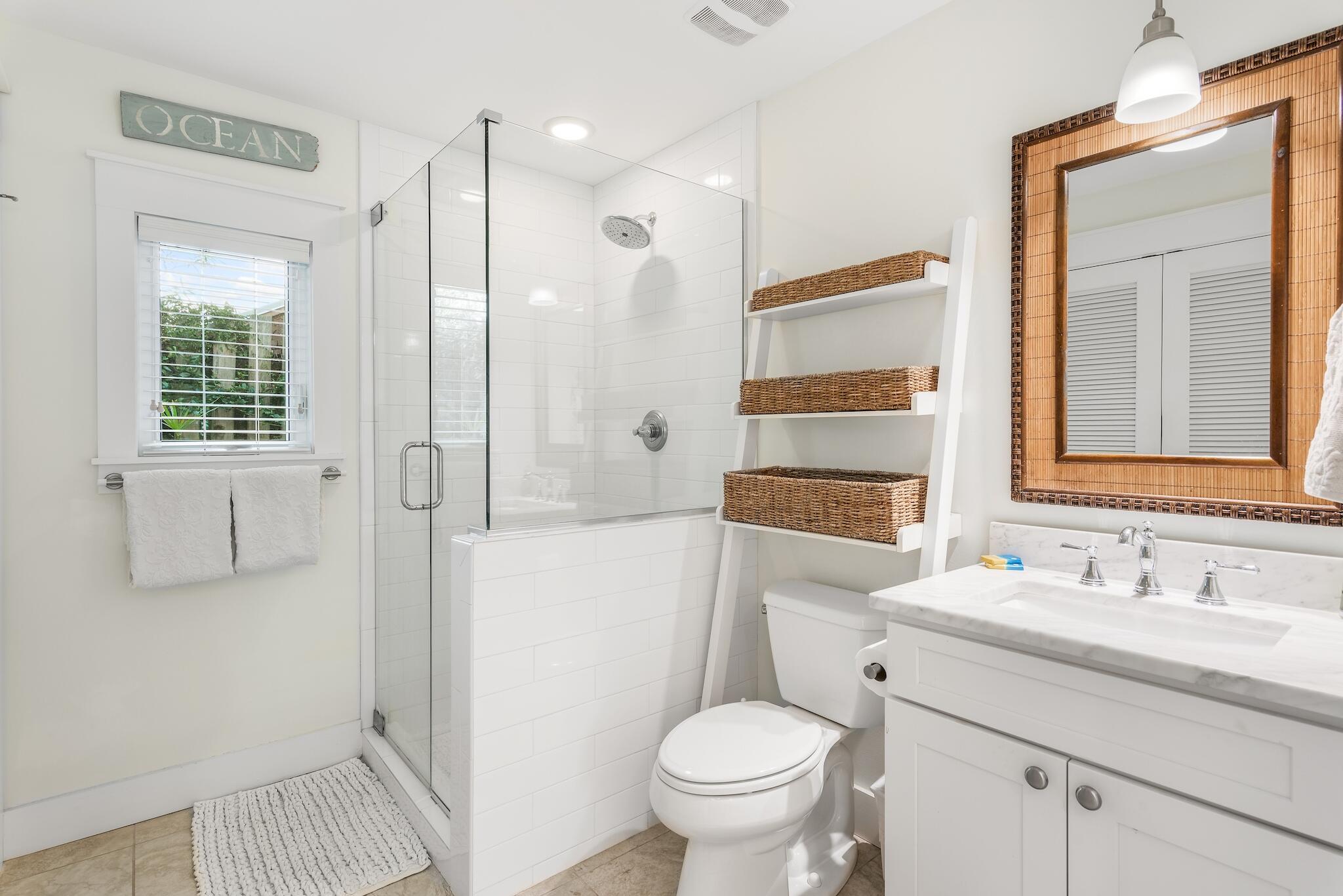 301 South Gulf Drive Santa Rosa Beach, FL 32459 - Photo 6 of 26 a bathroom with a sink a toilet and shower