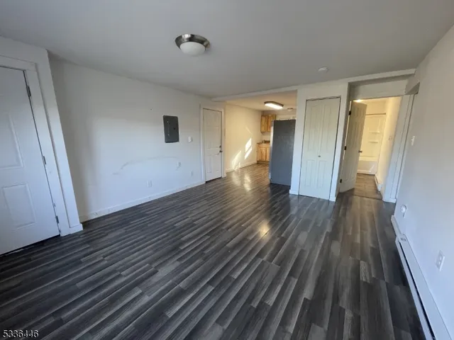 a view of a room with wooden floor and staircase